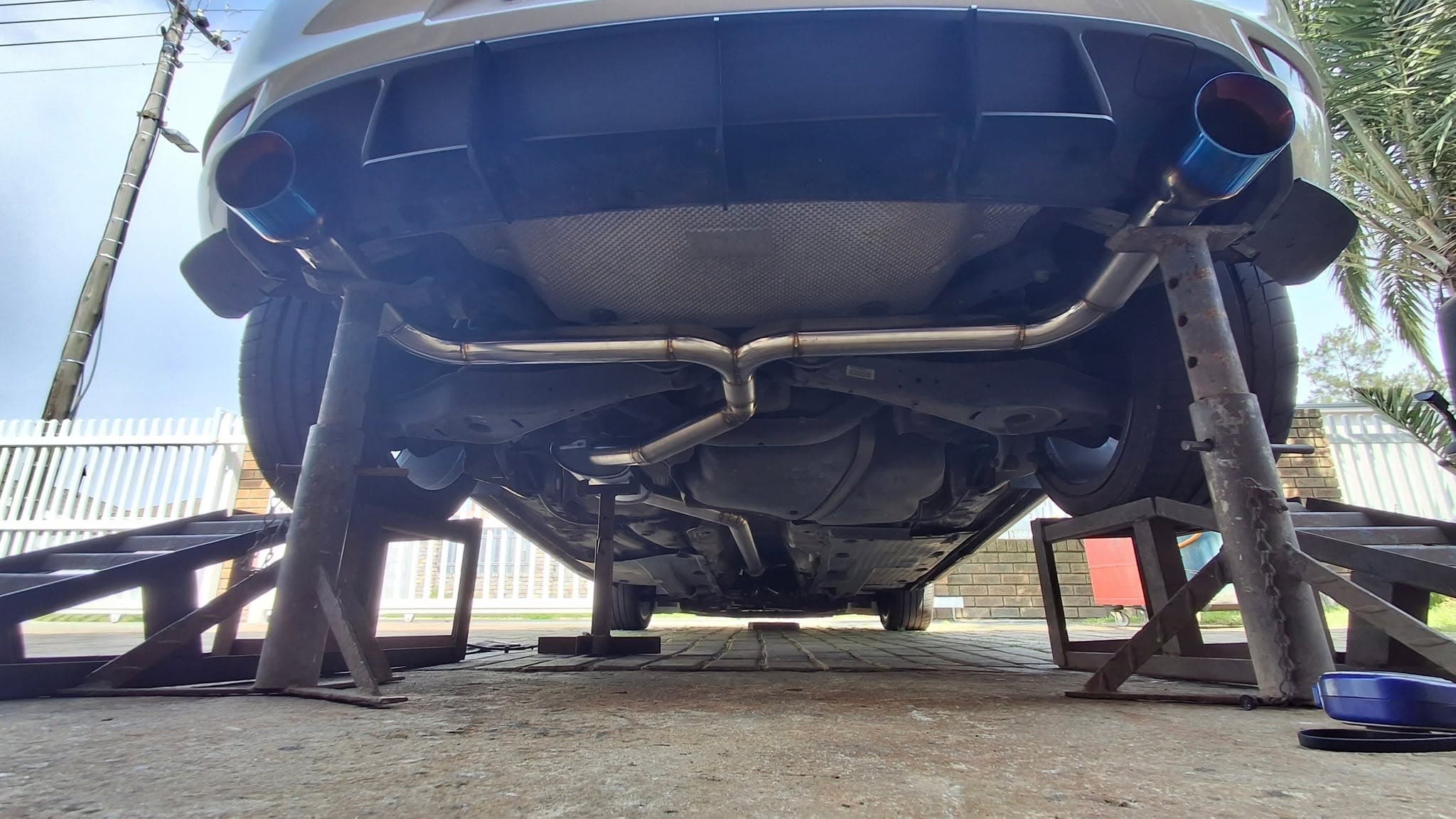 SteelFab custom stainless exhaust installed beneath a Golf GTI