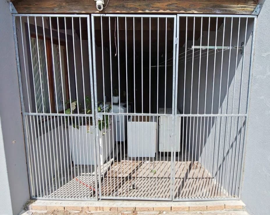 Custom galvanised safety gate installed in an existing doorway