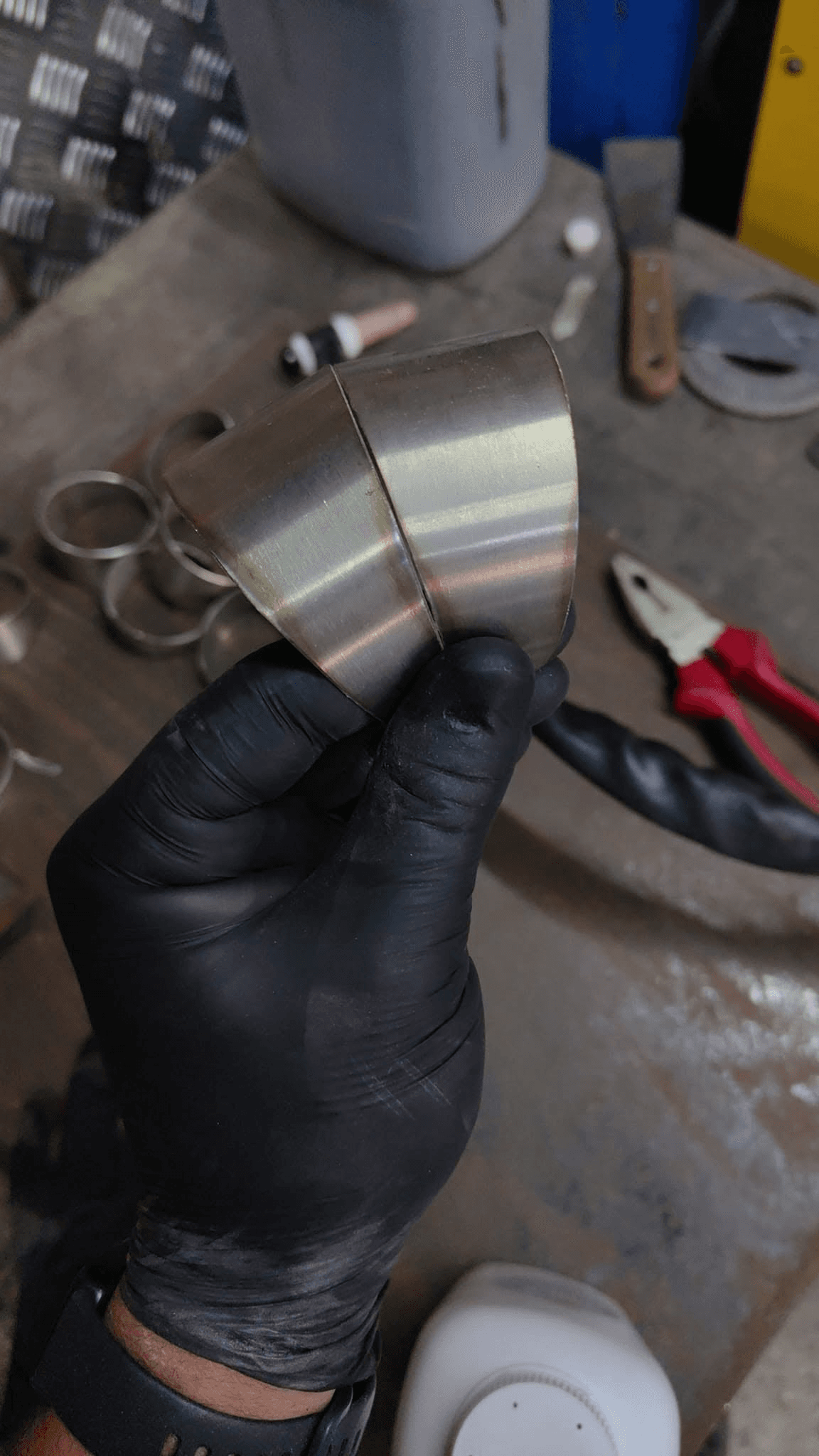 Stainless pipe sections being aligned by hand before fabrication